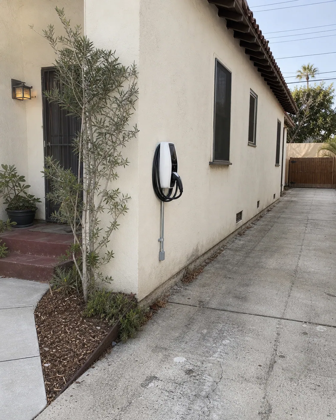 Outdoor EV charger installed beside the driveway of a Los Angeles Spanish-style home